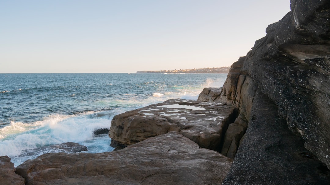 Sandstone cliff and rock platform beside the ocean near Sydney's coastal walk